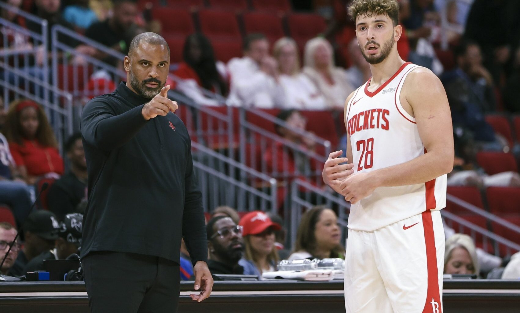 Oct 6, 2025; Houston, Texas, USA; Houston Rockets Head Coach Ime Udoka and center Alperen Sengun (28) react during the game against the Atlanta Hawks at Toyota Center. Mandatory Credit: Troy Taormina-Imagn Images