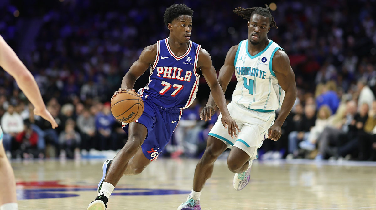 Philadelphia 76ers guard VJ Edgecombe (77) dribbles the ball past Charlotte Hornets guard Sion James (4) during the second quarter at Xfinity Mobile Arena.