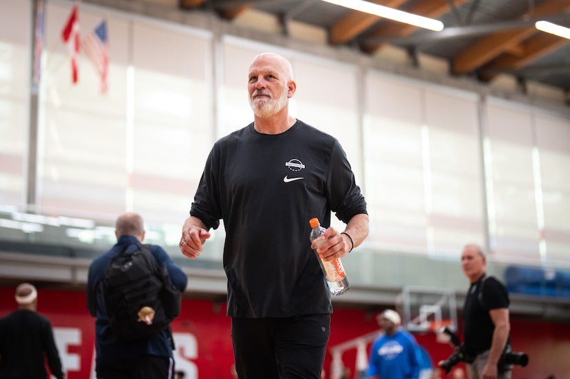 Dallas Mavericks assistant coach Jay Triano walks off the court at NBA basketball training...