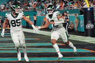 New York Jets' Mason Taylor (85) and Justin Fields (7) celebrate after Fields ran the ball...