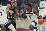 Minnesota Timberwolves guard Anthony Edwards (5) drives past Portland Trail Blazers forward Kris Murray (24) during the first half of an NBA basketball game on Wednesday, Oct. 22, 2025, in Portland, Ore.
