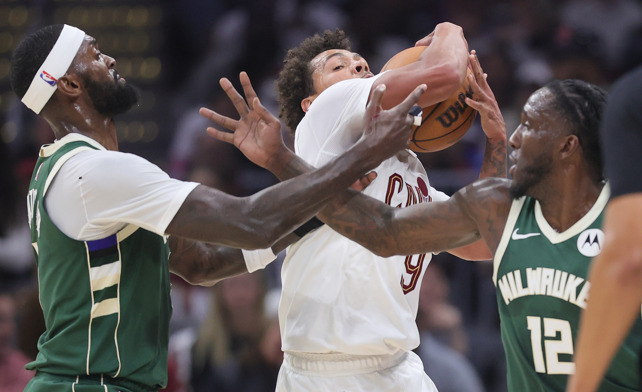 Cleveland Cavaliers guard Craig Porter Jr. (C) secures a loose ball from Milwaukee Bucks forward Bobby Portis (L) and Milwaukee Bucks forward Taurean Prince in the first half at Rocket Arena. 
