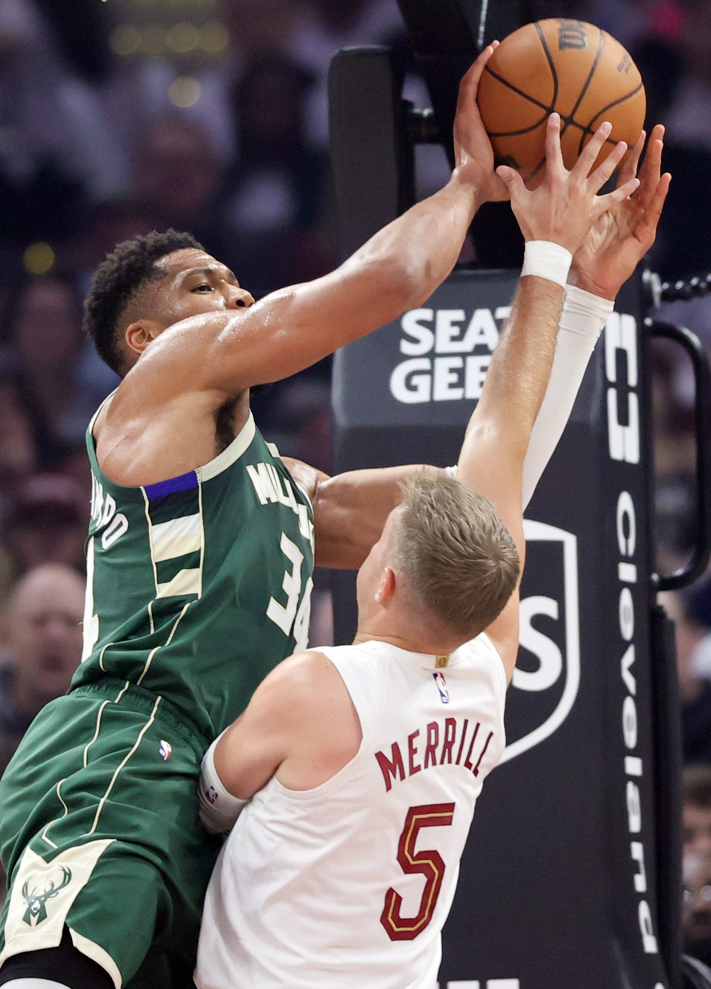 Milwaukee Bucks forward Giannis Antetokounmpo looks for an outlet pass guarded by Cleveland Cavaliers guard Sam Merrill in the first half at Rocket Arena. 