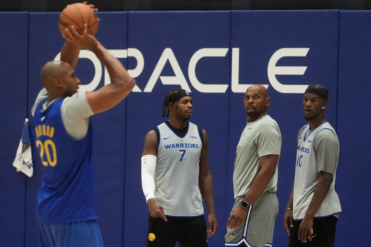 With Warriors Buddy Hield (7), assistant coach Jerry Stackhouse, and star forward Jimmy Butler (right) looking on, Golden State's newest addition, Al Horford, works out on Wednesday in San Francisco.