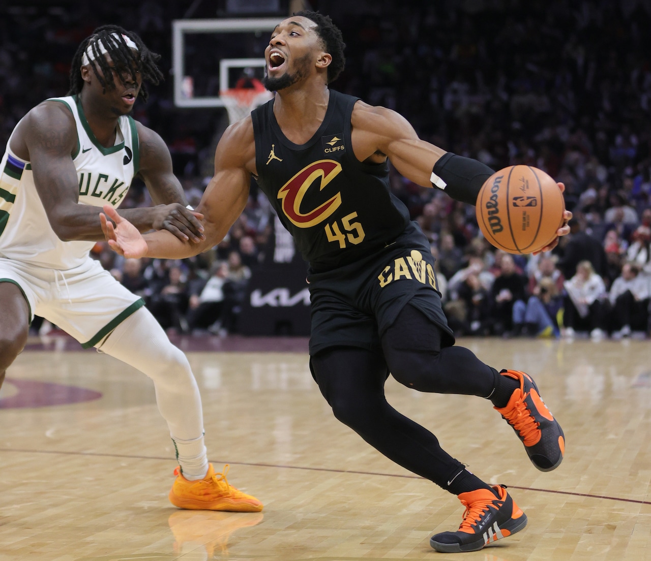 Cleveland Cavaliers guard Donovan Mitchell drives to the basket as he is fouled by Milwaukee Bucks forward Chris Livingston during the second half