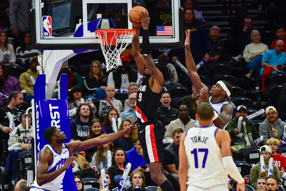 Oct 16, 2025; Salt Lake City, Utah, USA; Portland Trail Blazers forward Jerami Grant (9) makes a slam dunk during the second half against Utah Jazz forward Taylor Hendricks (0) at Delta Center.