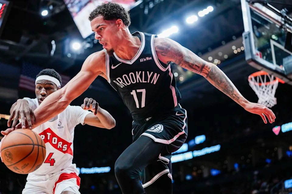 Oct 17, 2025; Toronto, Ontario, CAN; Brooklyn Nets forward Michael Porter Jr. (17) and Toronto Raptors guard Ja'Kobe Walter (14) battle for the ball during the third quarter at Scotiabank Arena.