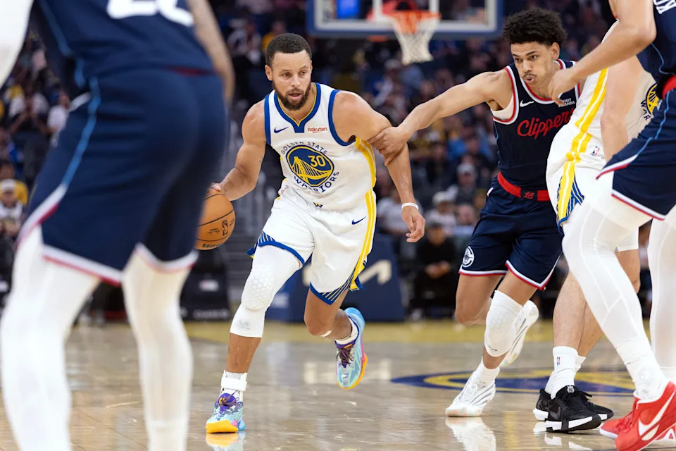 Oct 17, 2025; San Francisco, California, USA; Golden State Warriors guard Stephen Curry (30) drives past Los Angeles Clippers guard Kobe Sanders (4) during the first quarter at Chase Center.