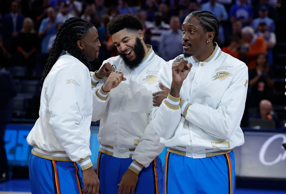 Oct 21, 2025; Oklahoma City, Oklahoma, USA; Oklahoma City Thunder guard Cason Wallace (22), guard Kenrich Williams (34) and guard Jalen Williams (8) celebrate after receiving their NBA Championship rings before a game against the Houston Rockets at Paycom Center. Mandatory Credit: Alonzo Adams-Imagn Images