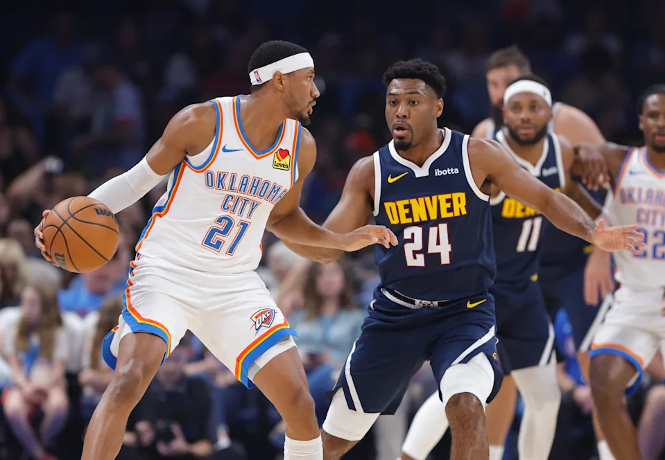 Oct 17, 2025; Oklahoma City, Oklahoma, USA; Oklahoma City Thunder guard Aaron Wiggins (21) moves the ball as Denver Nuggets guard Jalen Pickett (24) defends during the first half at Paycom Center. Mandatory Credit: Alonzo Adams-Imagn Images