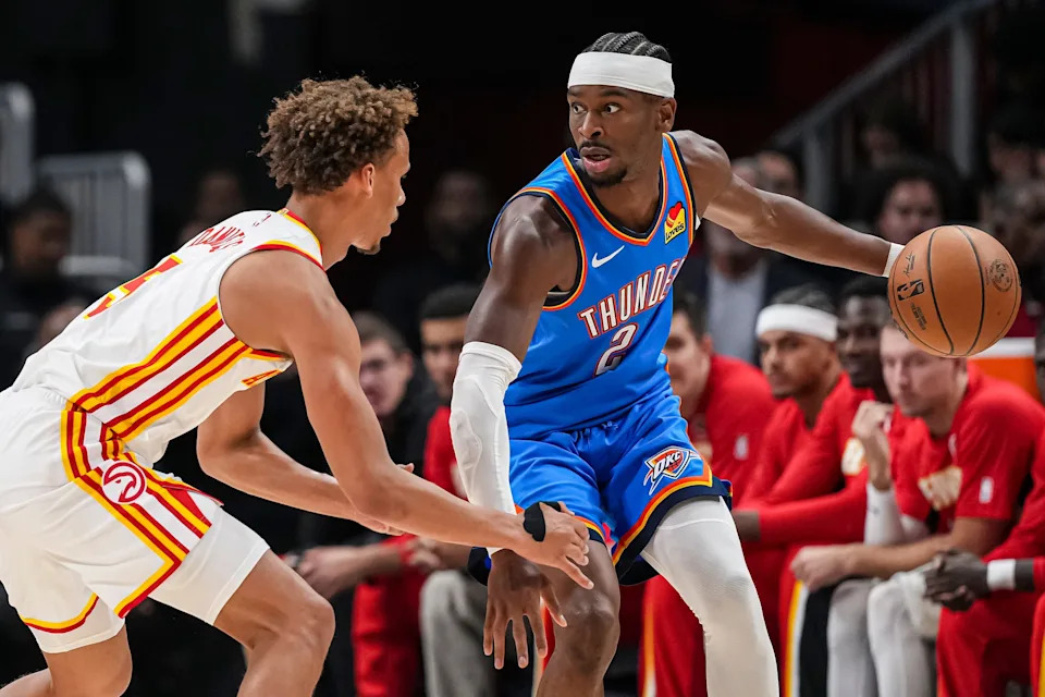 Oct 25, 2025; Atlanta, Georgia, USA; Oklahoma City Thunder guard Shai Gilgeous-Alexander (2) controls the ball against Atlanta Hawks guard Dyson Daniels (5) during the first half at State Farm Arena. Mandatory Credit: Dale Zanine-Imagn Images