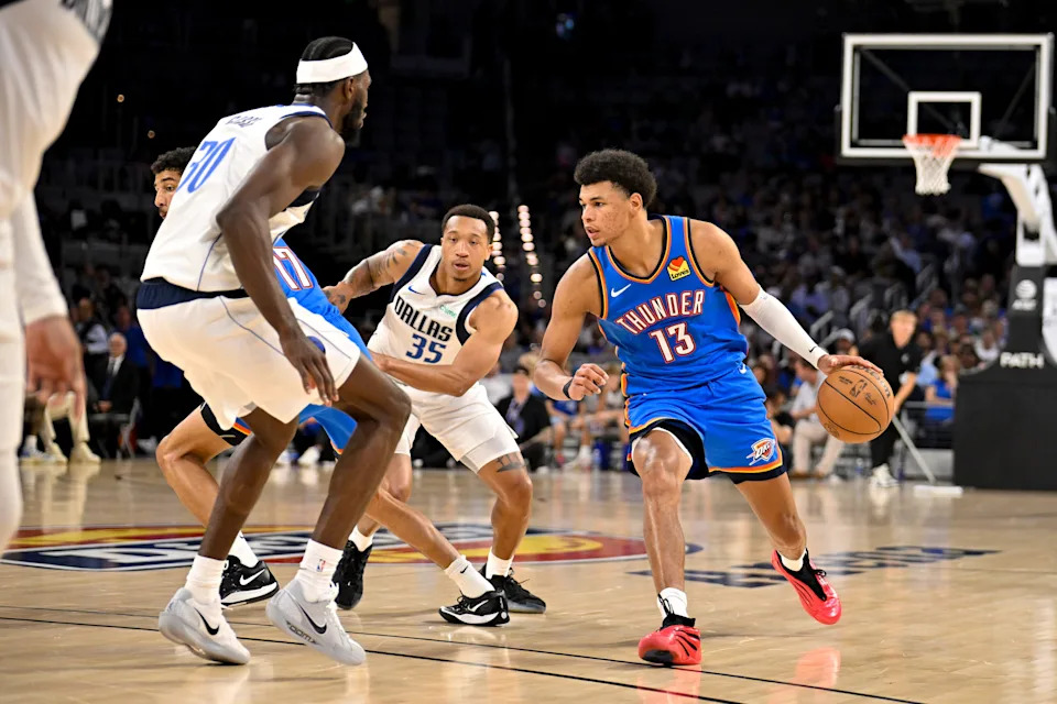 Oct 6, 2025; Fort Worth, Texas, USA; Oklahoma City Thunder forward Ousmane Dieng (13) looks to move the ball past Dallas Mavericks guard Matthew Cleveland (35) during the second half at Dickie's Arena. Mandatory Credit: Jerome Miron-Imagn Images