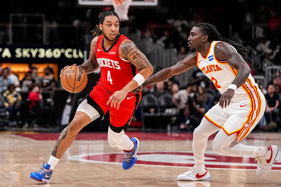 Oct 16, 2025; Atlanta, Georgia, USA; Houston Rockets guard JD Davison (4) dribbles defended by Atlanta Hawks guard Keaton Wallace (2) during the second half at State Farm Arena.