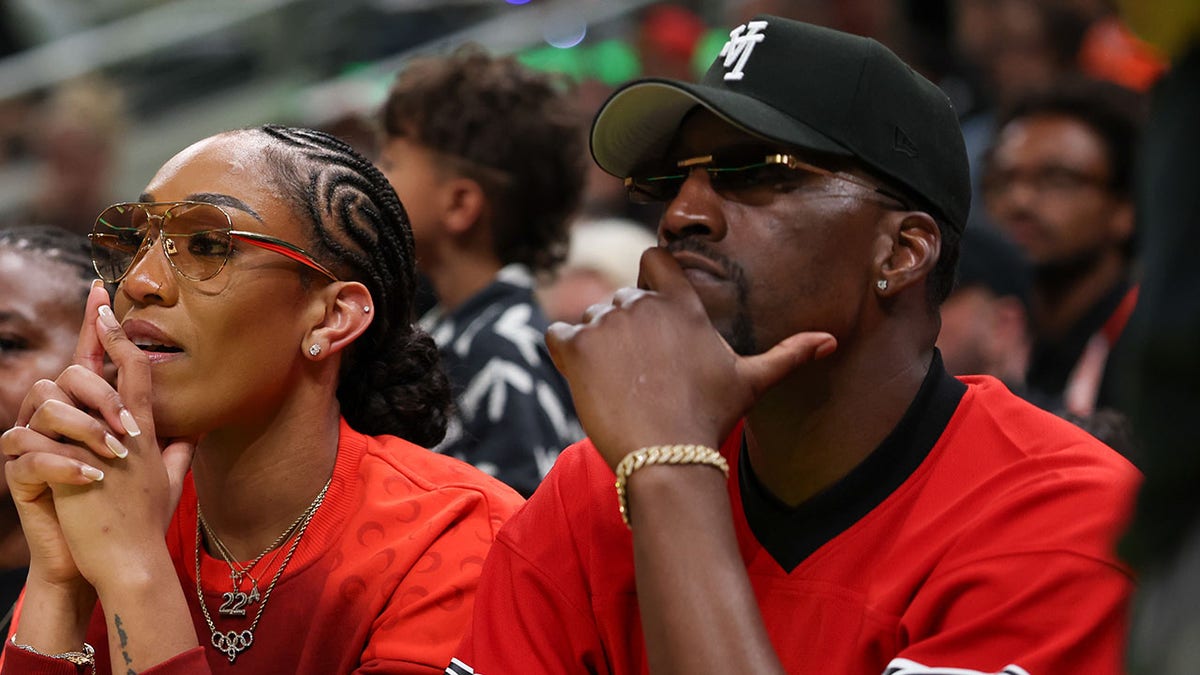 A'ja Wilson and Bam Adebayo watch a WNBA game