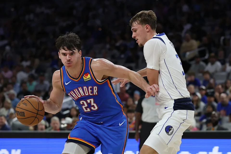 FORT WORTH, TEXAS - OCTOBER 06: Brooks Barnhizer #23 of the Oklahoma City Thunder is defended by Cooper Flagg #32 of the Dallas Mavericks during the first half of a preseason game at Dickies Arena on October 06, 2025 in Fort Worth, Texas. NOTE TO USER: User expressly acknowledges and agrees that, by downloading and or using this photograph, User is consenting to the terms and conditions of the Getty Images License Agreement. (Photo by Stacy Revere/Getty Images)