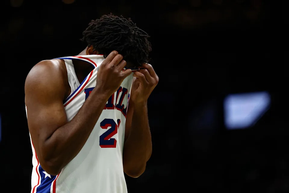 Oct 22, 2025; Boston, Massachusetts, USA; Philadelphia 76ers center Joel Embiid (21) wipes sweat from his face during the second quarter against the Boston Celtics at TD Garden. Credit: Winslow Townson-Imagn Images