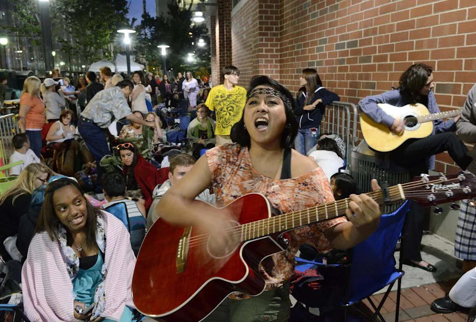 June 19, 2012: American Idol auditioner Sky Noblezada, 17, of Mooresville sings for the crowd as she waits in line to audition in 2012.