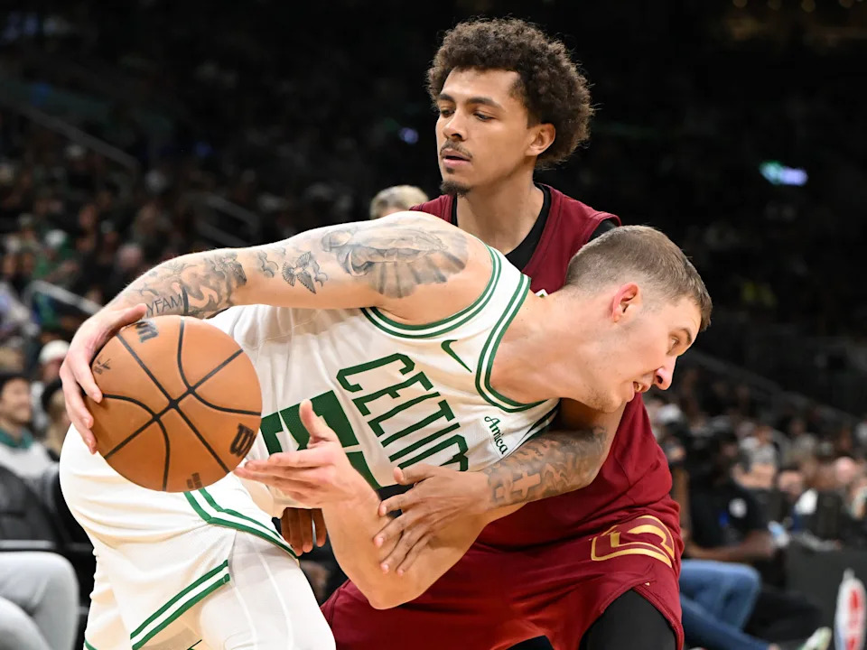 Oct 12, 2025; Boston, Massachusetts, USA; Boston Celtics guard Baylor Scheierman (55) drives to the basket against Cleveland Cavaliers guard Craig Porter Jr. (9) during the second half at TD Garden. Mandatory Credit: Brian Fluharty-Imagn Images