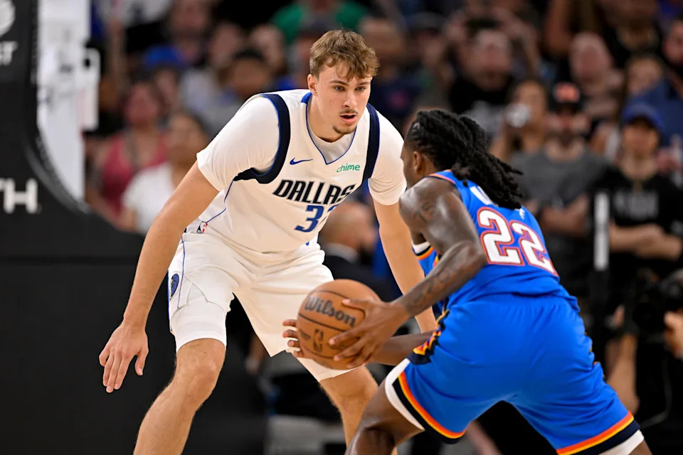 Oct 6, 2025; Fort Worth, Texas, USA; Oklahoma City Thunder guard Cason Wallace (22) looks to move the ball past Dallas Mavericks forward Cooper Flagg (32) during the first quarter at Dickie's Arena. Mandatory Credit: Jerome Miron-Imagn Images