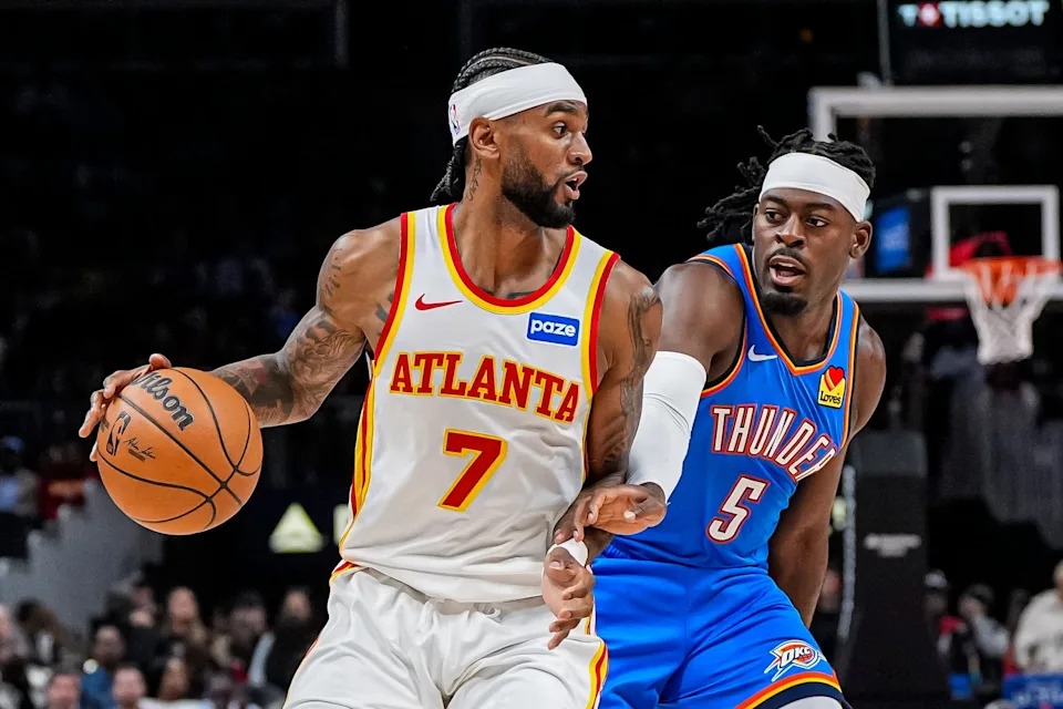 Oct 25, 2025; Atlanta, Georgia, USA; Atlanta Hawks guard Nickeil Alexander-Walker (7) is defended by Oklahoma City Thunder guard Luguentz Dort (5) during the first half at State Farm Arena. Mandatory Credit: Dale Zanine-Imagn Images