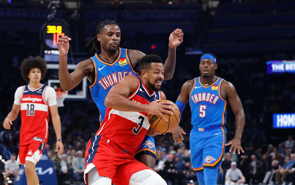 Oct 30, 2025; Oklahoma City, Oklahoma, USA; Washington Wizards guard CJ McCollum (3) drives past Oklahoma City Thunder guard Cason Wallace (22) during the second quarter at Paycom Center. Mandatory Credit: Alonzo Adams-Imagn Images