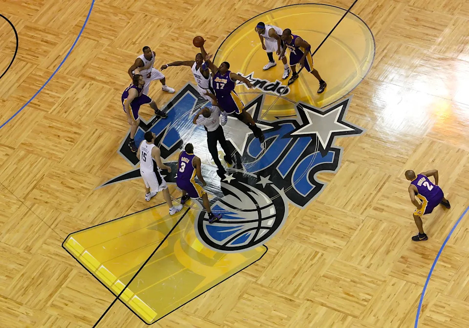 ORLANDO, FL - JUNE 14:  Andrew Bynum #17 of the Los Angeles Lakers and Dwight Howard #12 of the Orlando Magic go after the tip-off to start Game Five of the 2009 NBA Finals on June 14, 2009 at Amway Arena in Orlando, Florida.  NOTE TO USER:  User expressly acknowledges and agrees that, by downloading and or using this photograph, User is consenting to the terms and conditions of the Getty Images License Agreement.  (Photo by Ronald Martinez/Getty Images)