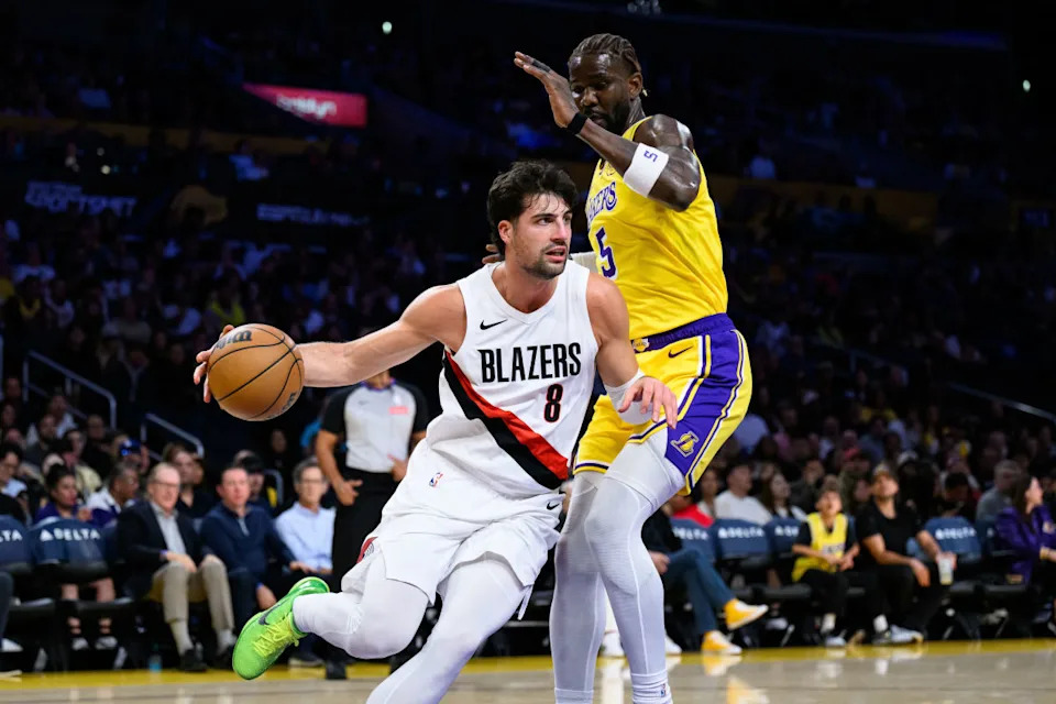 Oct 27, 2025; Los Angeles, California, USA; Portland Trail Blazers forward Deni Avdija (8) drives the ball while under pressure from Los Angeles Lakers center Deandre Ayton (5) during the first half at Crypto.com Arena. Mandatory Credit: William Liang-Imagn ImagesCredit&colon; William Liang-Imagn Images