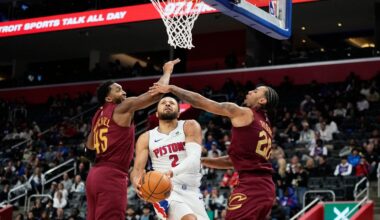 Detroit Pistons guard Cade Cunningham, center, shoots against Cleveland Cavaliers guards Donovan Mitchell, left, and Jaylon Tyson during the first half of an NBA basketball game, Monday, Oct. 27, 2025, in Detroit. (AP Photo/Ryan Sun)