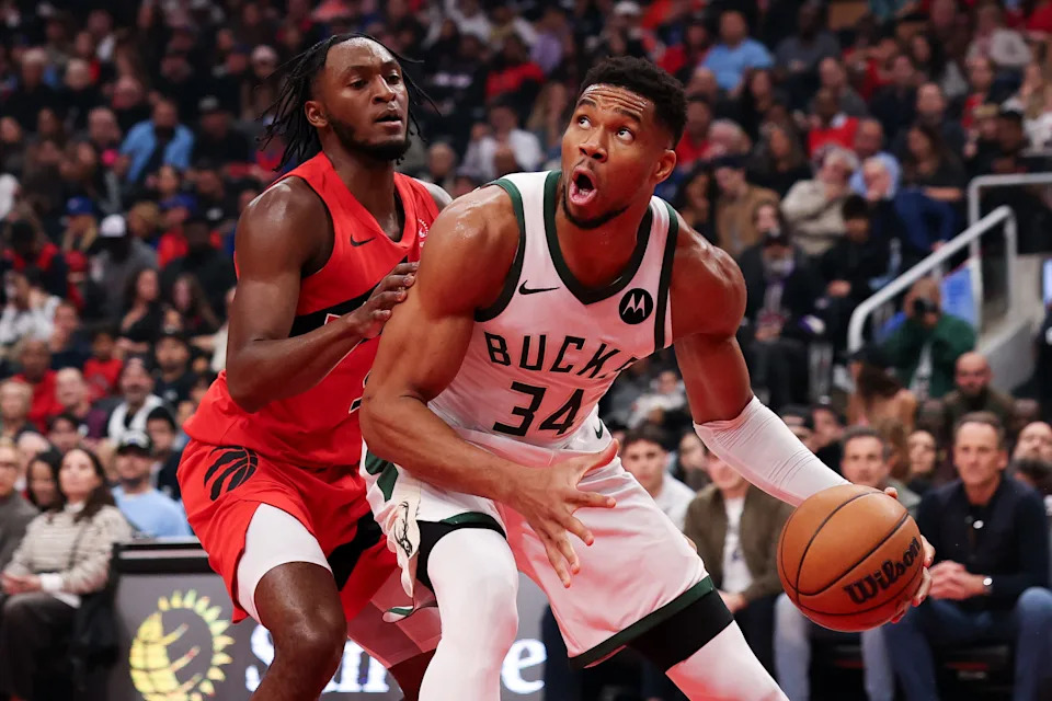 Giannis Antetokounmpo of the Milwaukee Bucks works against defender Immanuel Quickley of the Toronto Raptors during the first half at Scotiabank Arena on Oct. 24 in Toronto.