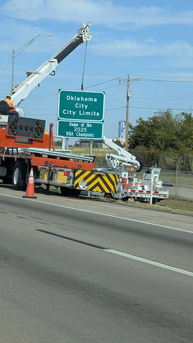 Workers installing new 2025 NBA Champions signs. 2025 nba champions signs being installed in oklahoma city.