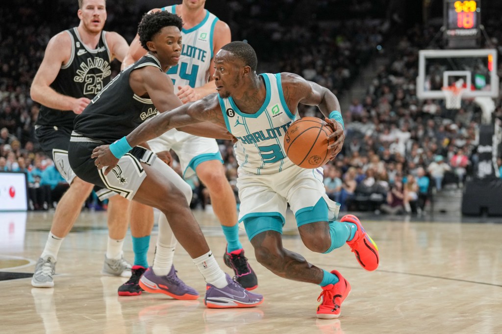 Charlotte Hornets guard Terry Rozier dribbles past San Antonio Spurs guard Joshua Primo.