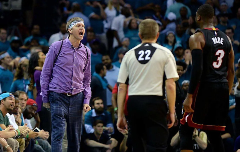 April 29, 2016: Miami Heat guard Dwyane Wade (right) stares at a Charlotte Hornets fan soon to be nicknamed “Purple Shirt Guy” after Wade hit a jumper during fourth-quarter action in Game 6 of an NBA playoff series. The Hornets ultimately lost the game due to Wade’s heroics, and soon thereafter lost the series.