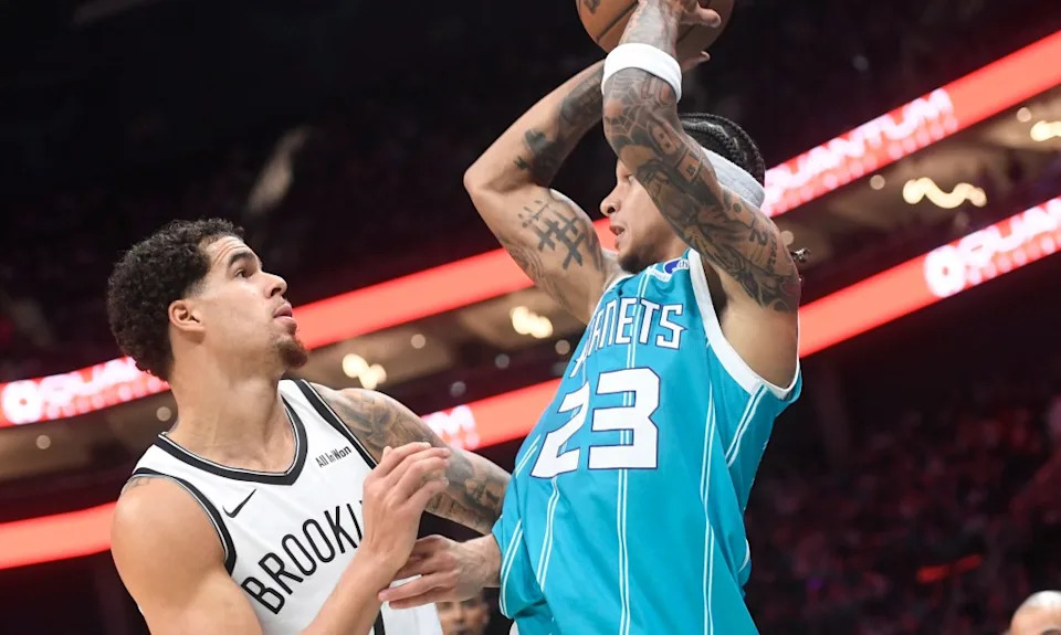 Michael Porter Jr. (left) defends as Tre Mann looks to pass during the Nets’ opening-night road loss to the Hornets. Sam Sharpe-Imagn Images