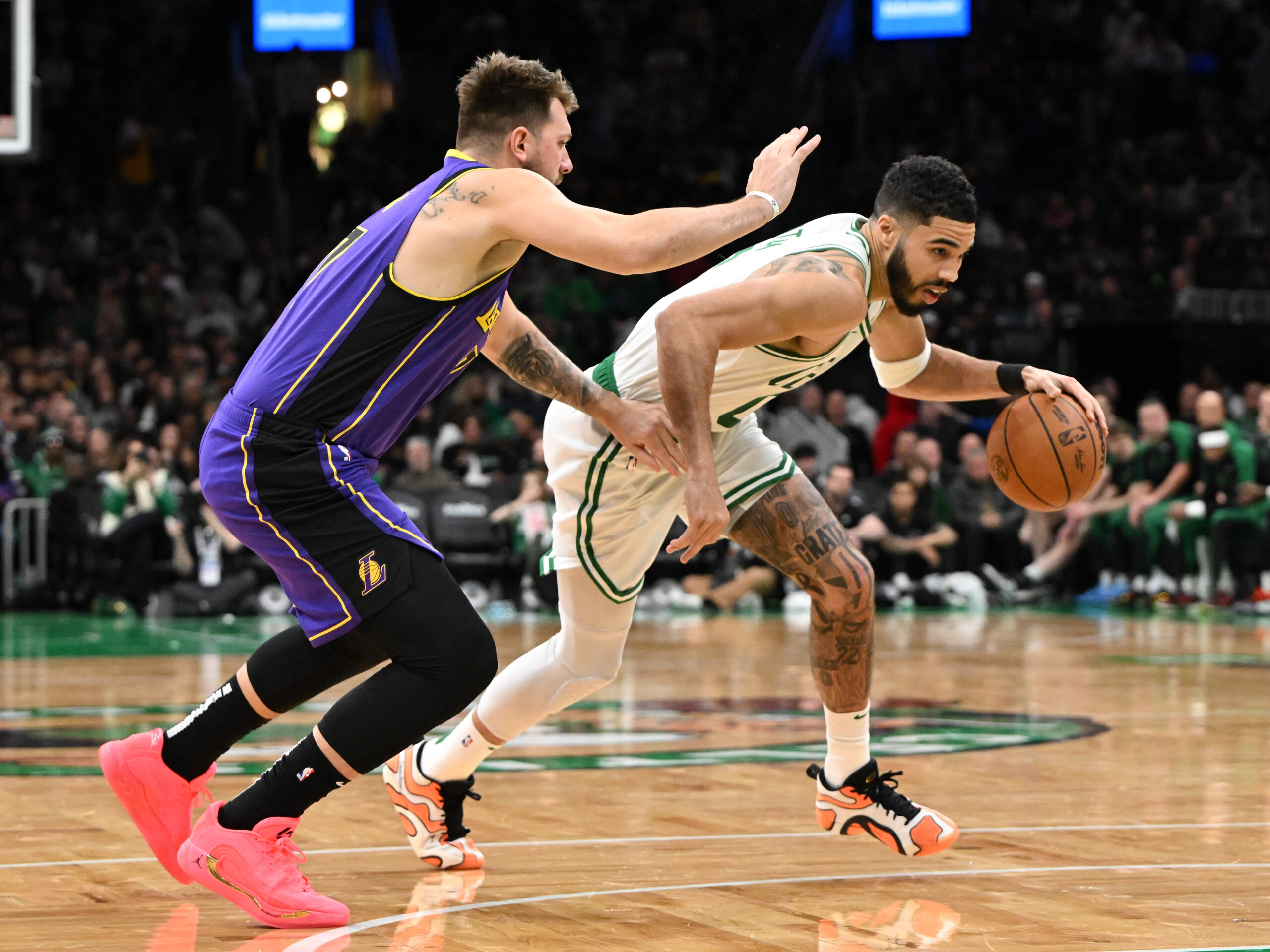 Boston Celtics forward Jayson Tatum drives to the basket against Los Angeles Lakers guard Luka Doncic during the fourth quarter at the TD Garden.