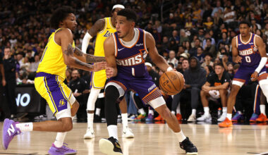 Devin Booker #1 of the Phoenix Suns drives around a Los Angeles Lakers defender during the second h...