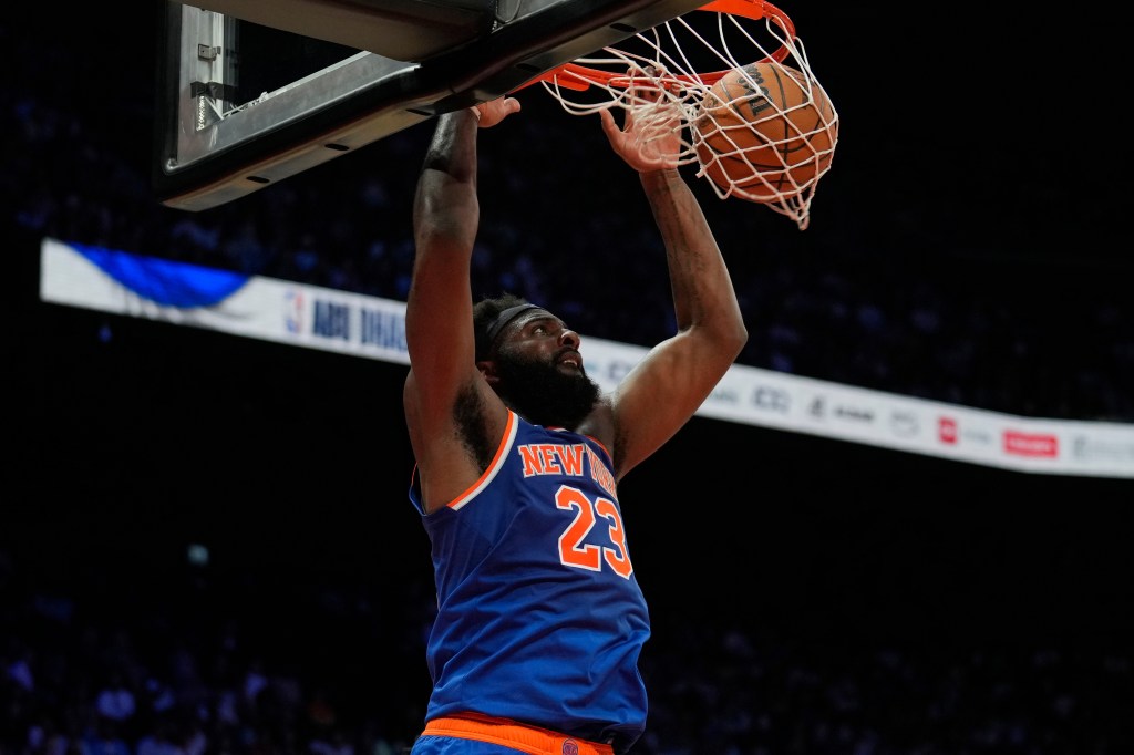 Mitchell Robinson dunks against the Philadelphia 76ers.