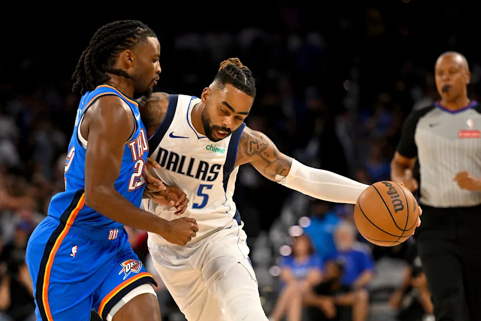 Oct 6, 2025; Fort Worth, Texas, USA; Dallas Mavericks guard D'Angelo Russell (5) drives to the basket past Oklahoma City Thunder guard Cason Wallace (22) during the first quarter at Dickie's Arena. Mandatory Credit: Jerome Miron-Imagn Images