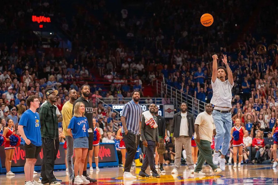 Former Kansas Jayhawks guard Zeke Mayo takes a half-court shot to win a prize for a fan during Late Night in the Phog on Friday, October 17, 2025, in Lawrence.