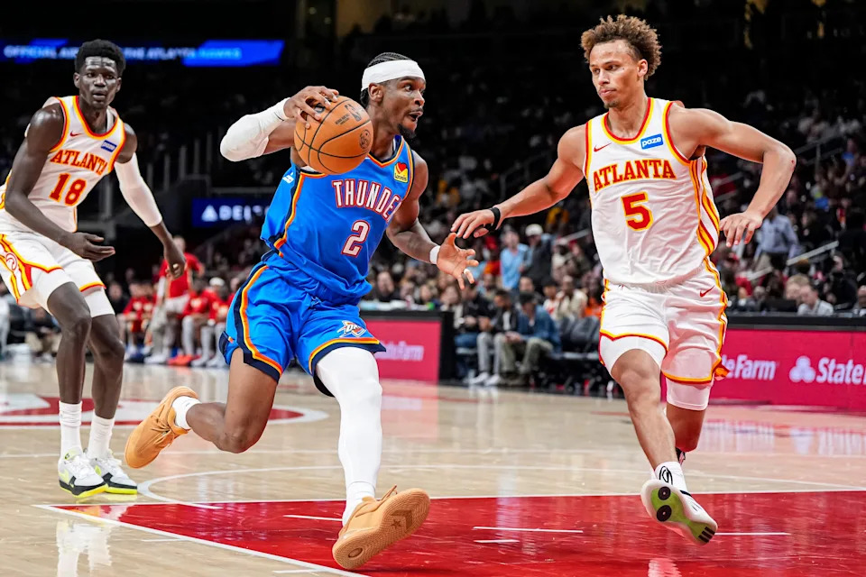 Oct 25, 2025; Atlanta, Georgia, USA; Oklahoma City Thunder guard Shai Gilgeous-Alexander (2) dribbles against Atlanta Hawks guard Dyson Daniels (5) during the second half at State Farm Arena. Mandatory Credit: Dale Zanine-Imagn Images