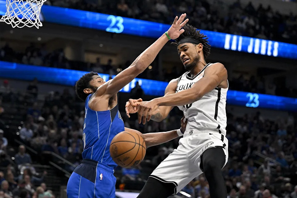 Mar 31, 2025; Dallas, Texas, USA; Dallas Mavericks guard Spencer Dinwiddie (26) and Brooklyn Nets center Nic Claxton (33) battle for the ball during the second half at the American Airlines Center. Mandatory Credit: Jerome Miron-Imagn Images