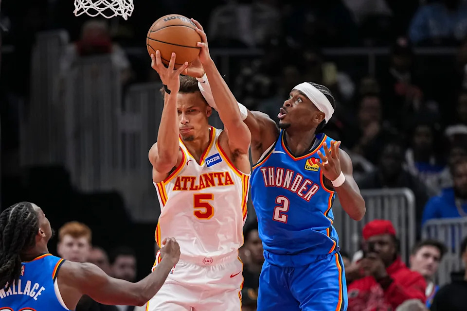 Oct 25, 2025; Atlanta, Georgia, USA; Atlanta Hawks guard Dyson Daniels (5) and Oklahoma City Thunder guard Shai Gilgeous-Alexander (2) fight for a rebound during the second half at State Farm Arena. Mandatory Credit: Dale Zanine-Imagn Images