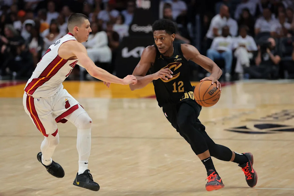 Apr 26, 2025; Miami, Florida, USA; Cleveland Cavaliers forward De'Andre Hunter (12) drives to the basket against Miami Heat guard Tyler Herro (14) in the fourth quarter during game three for the first round of the 2024 NBA Playoffs at Kaseya Center. Mandatory Credit: Sam Navarro-Imagn Images