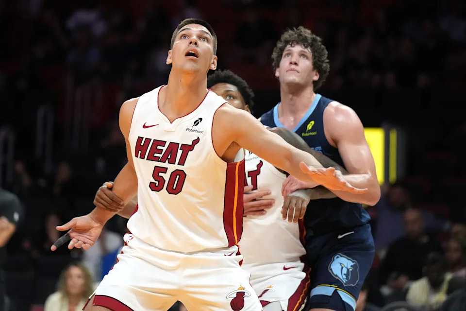 Oct 17, 2025; Miami, Florida, USA; Miami Heat center Vladislav Goldin (50) battles for a rebound as Memphis Grizzlies center PJ Hall (16) closes in during the second half at Kaseya Center.