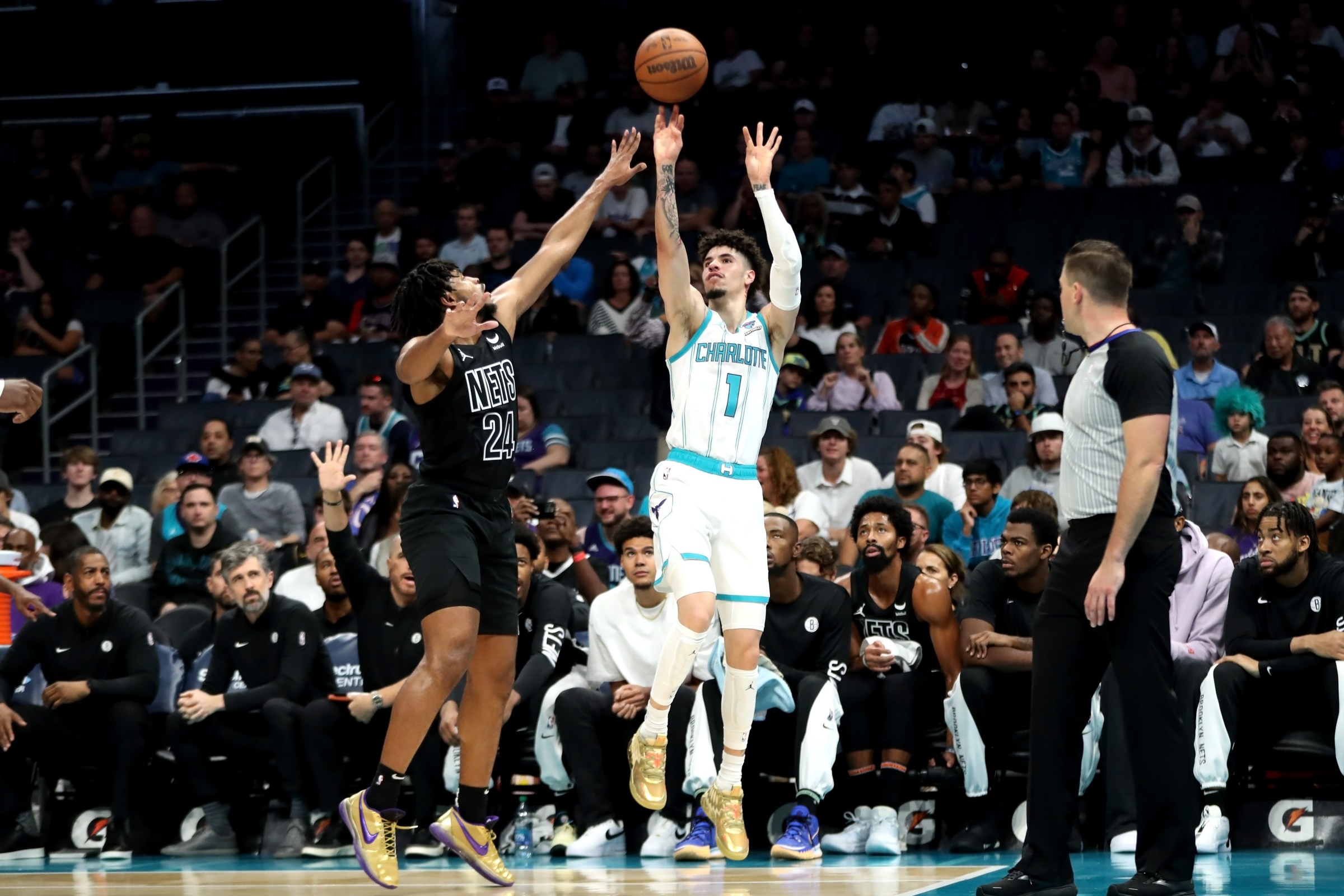 CHARLOTTE, NORTH CAROLINA - OCTOBER 30: LaMelo Ball #1 of the Charlotte Hornets shoots the ball over Cam Thomas #24 of the Brooklyn Nets during the first half of an NBA game at Spectrum Center on October 30, 2023 in Charlotte, North Carolina. NOTE TO USER: User expressly acknowledges and agrees that, by downloading and or using this photograph, User is consenting to the terms and conditions of the Getty Images License Agreement. (Photo by David Jensen/Getty Images)