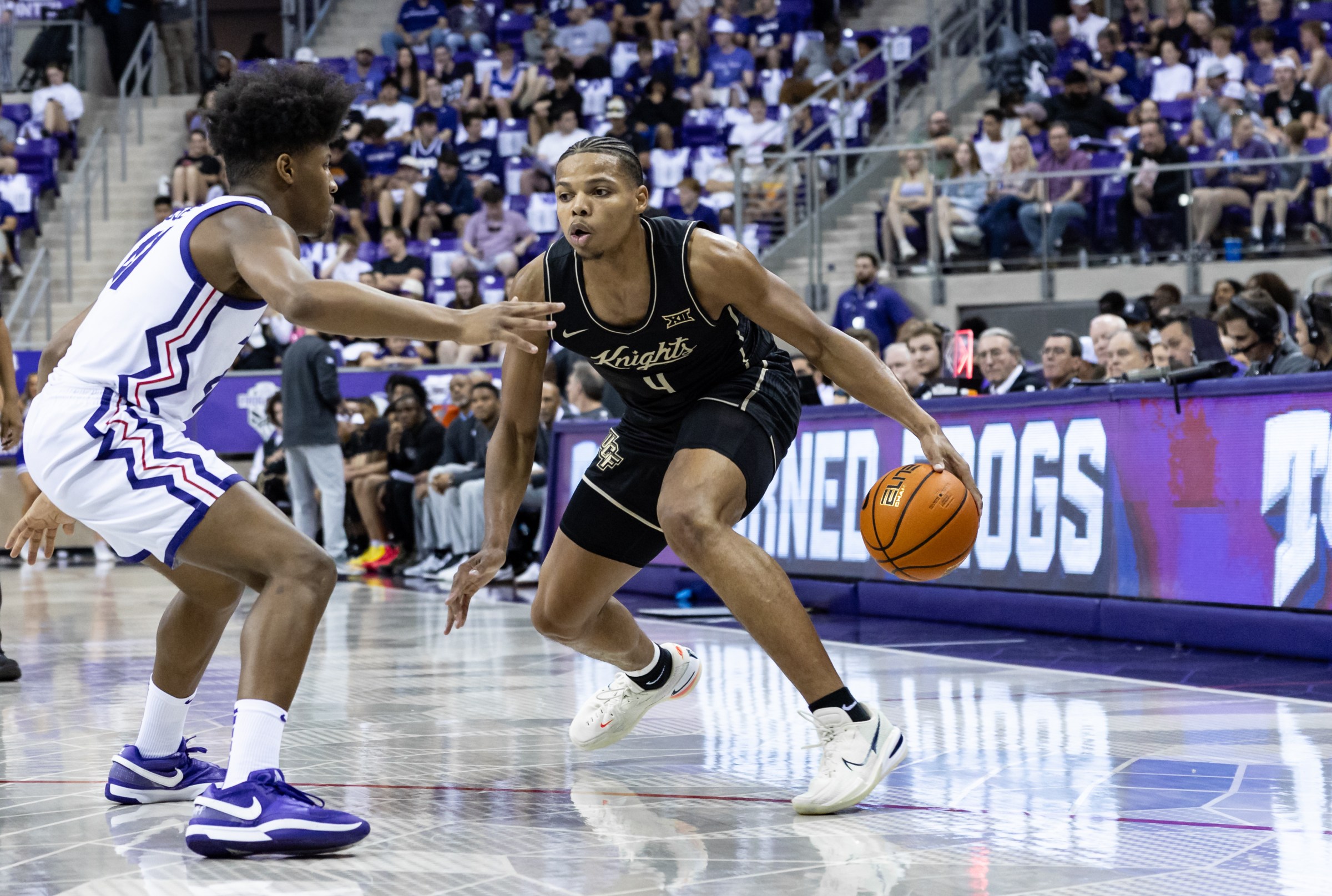 FORT WORTH, TX - MARCH 01: UCF Knights guard Keyshawn Hall (#4) dribbles the ball as TCU Horned Frogs forward Jace Posey (#41) applies pressure eduring the Big 12 college basketball game between the TCU Horned Frogs and UCF Knights on March 1, 2025 at Ed & Rae Schollmaier Arena in Fort Worth, Texas. (Photo by Matthew Visinsky/Icon Sportswire via Getty Images)