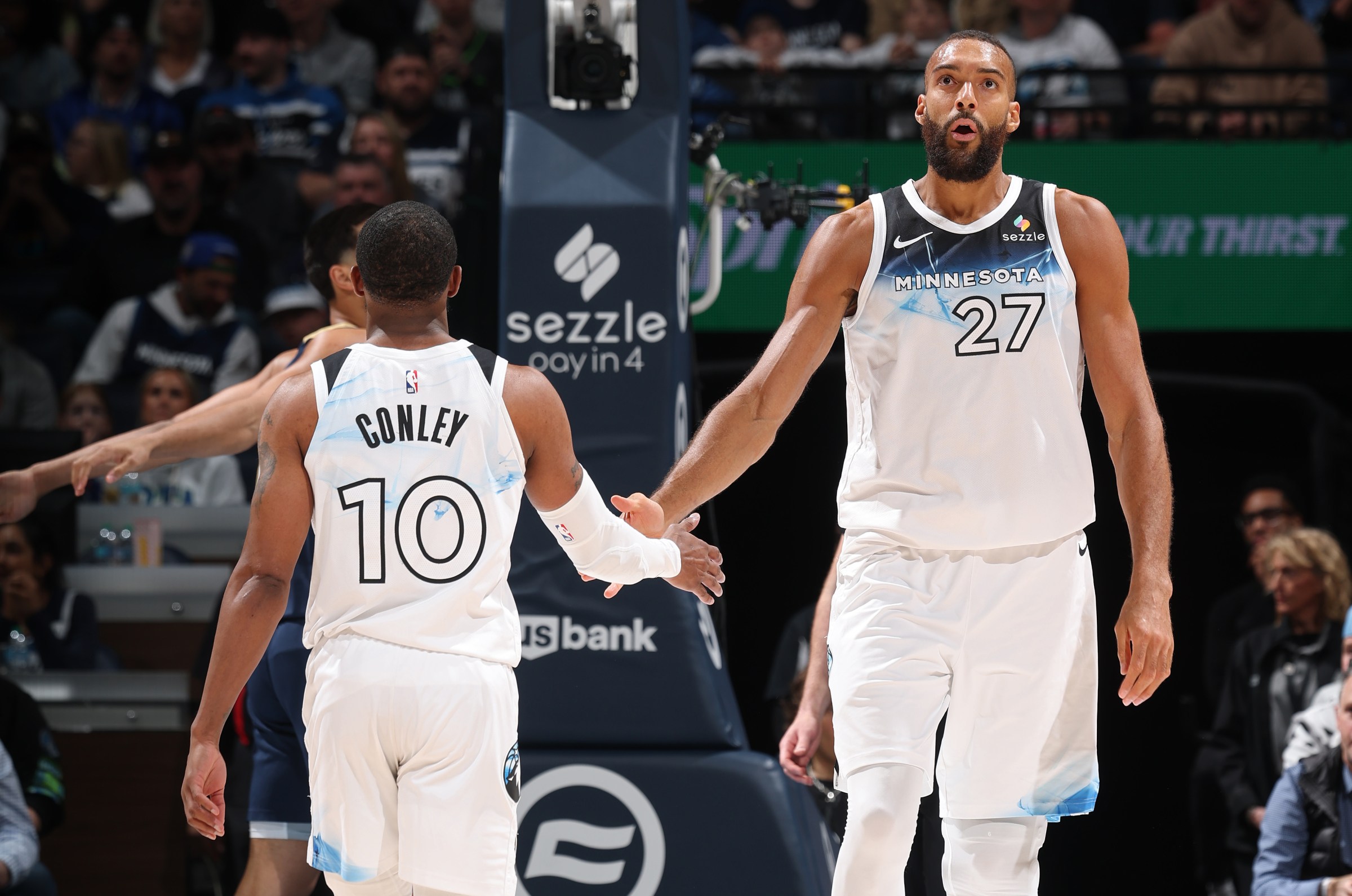 MINNEAPOLIS, MN - MARCH 21: Rudy Gobert #27 of the Minnesota Timberwolves high fives Mike Conley #10 during the game against the New Orleans Pelicans on March 21, 2025 at Target Center in Minneapolis, Minnesota. NOTE TO USER: User expressly acknowledges and agrees that, by downloading and or using this Photograph, user is consenting to the terms and conditions of the Getty Images License Agreement. Mandatory Copyright Notice: Copyright 2025 NBAE(Photo by David Sherman/NBAE via Getty Images)