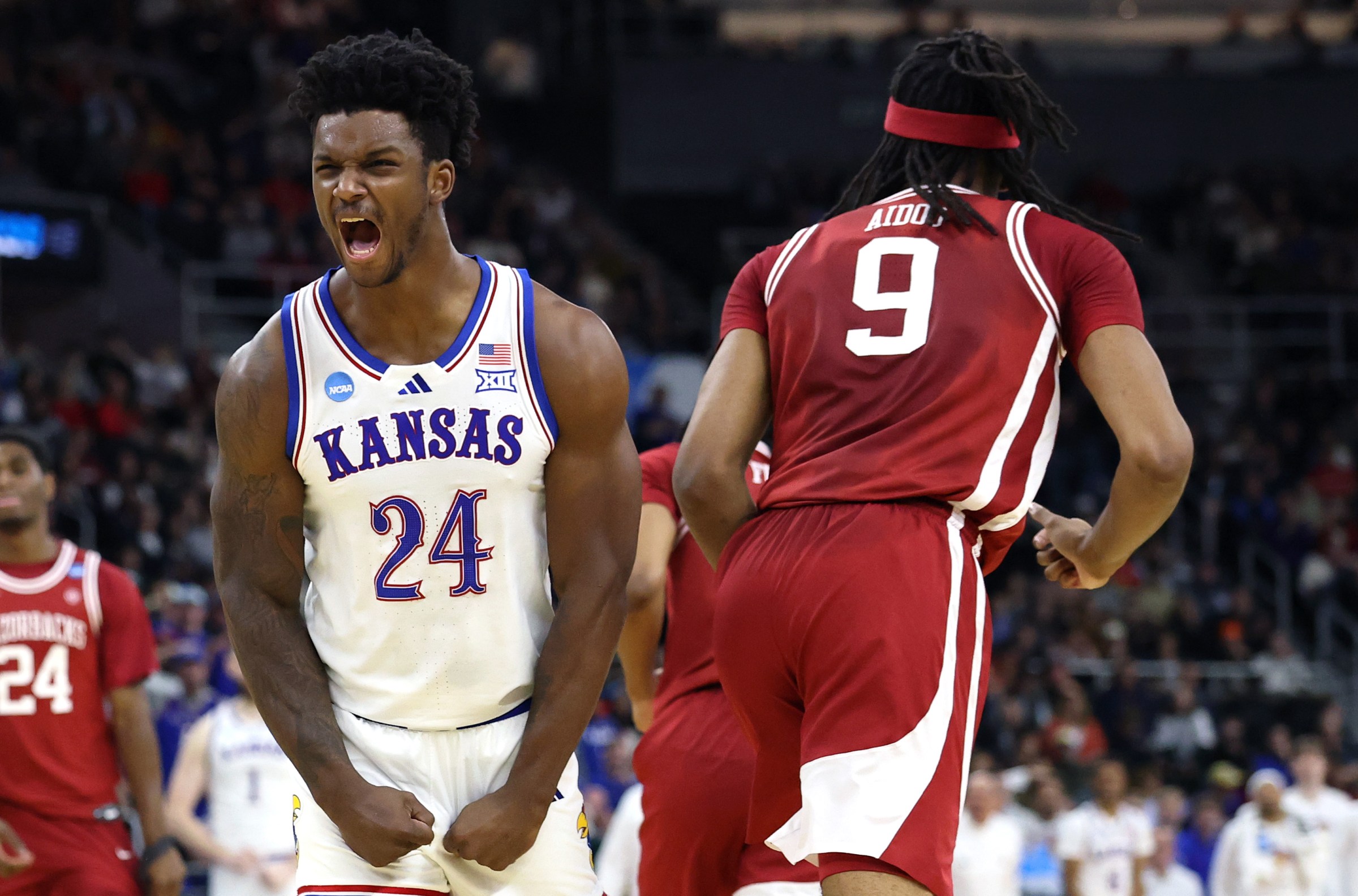 PROVIDENCE, RHODE ISLAND - MARCH 20: KJ Adams Jr. #24 of the Kansas Jayhawks celebrates after a dunk by Flory Bidunga #40 during the first half in the first round of the NCAA Men’s Basketball Tournament against the Arkansas Razorbacks at Amica Mutual Pavillion on March 20, 2025 in Providence, Rhode Island. (Photo by Emilee Chinn/Getty Images)
