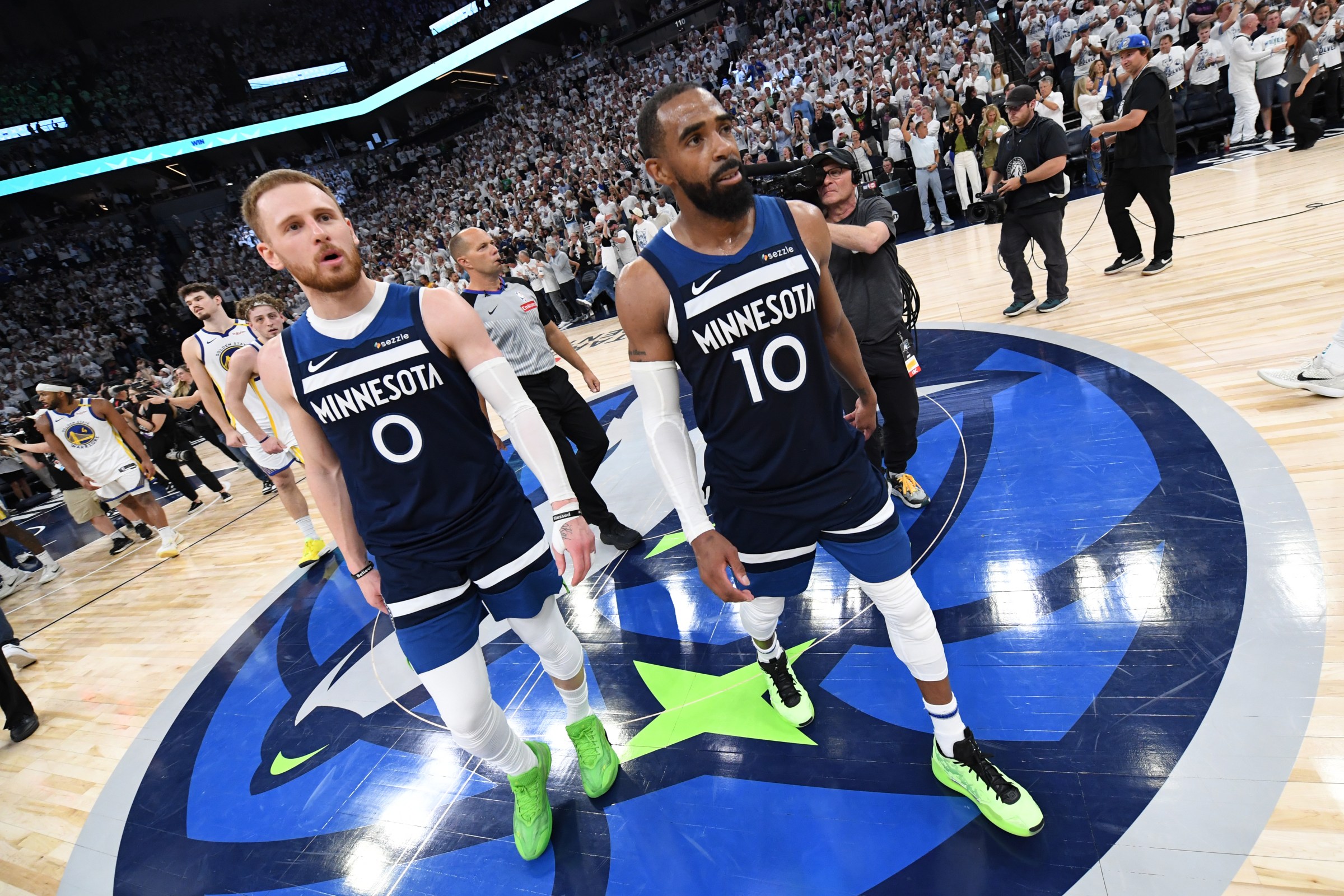 MINNEAPOLIS, MN - MAY 14: Donte DiVincenzo #0 and Mike Conley #10 of the Minnesota Timberwolves look on after the game against the Golden State Warriors during Round 2 Game 5 of the 2025 NBA Playoffs on May 14, 2025 at Target Center in Minneapolis, Minnesota. NOTE TO USER: User expressly acknowledges and agrees that, by downloading and or using this Photograph, user is consenting to the terms and conditions of the Getty Images License Agreement. Mandatory Copyright Notice: Copyright 2025 NBAE (Photo by Noah Graham/NBAE via Getty Images)