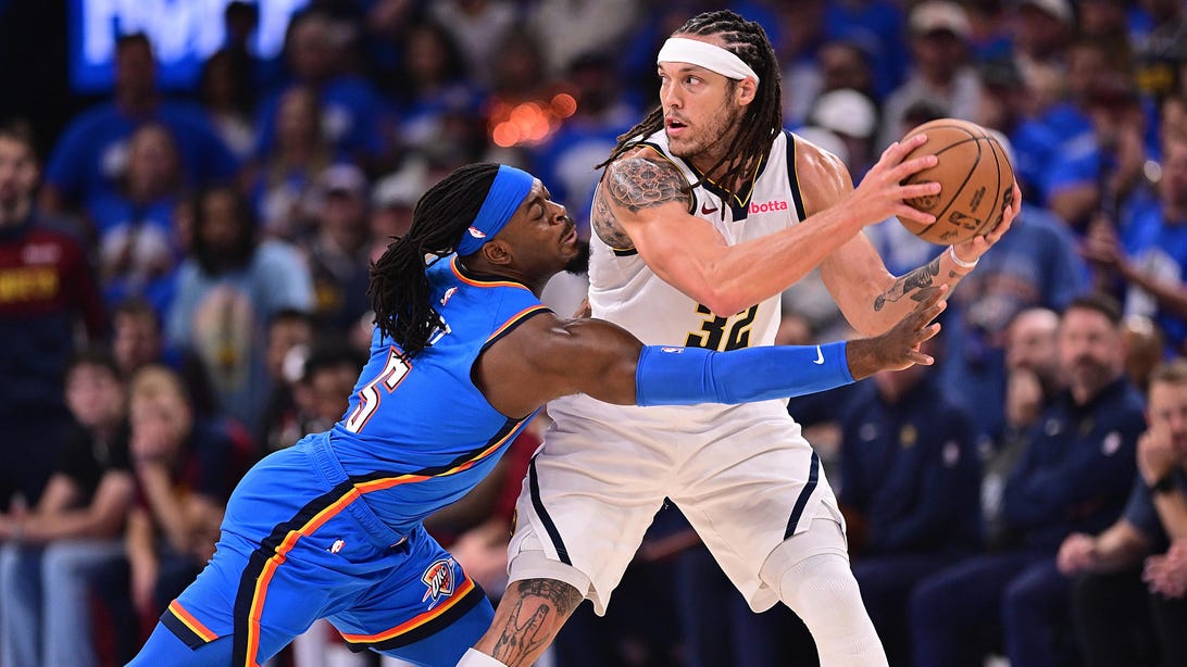 OKLAHOMA CITY, OKLAHOMA - MAY 18: Aaron Gordon #32 of the Denver Nuggets handles the ball while being defended by Luguentz Dort #5 of the Oklahoma City Thunder during the first half of game seven of the Western Conference semifinals at Paycom Center on May 18, 2025 in Oklahoma City, Oklahoma.