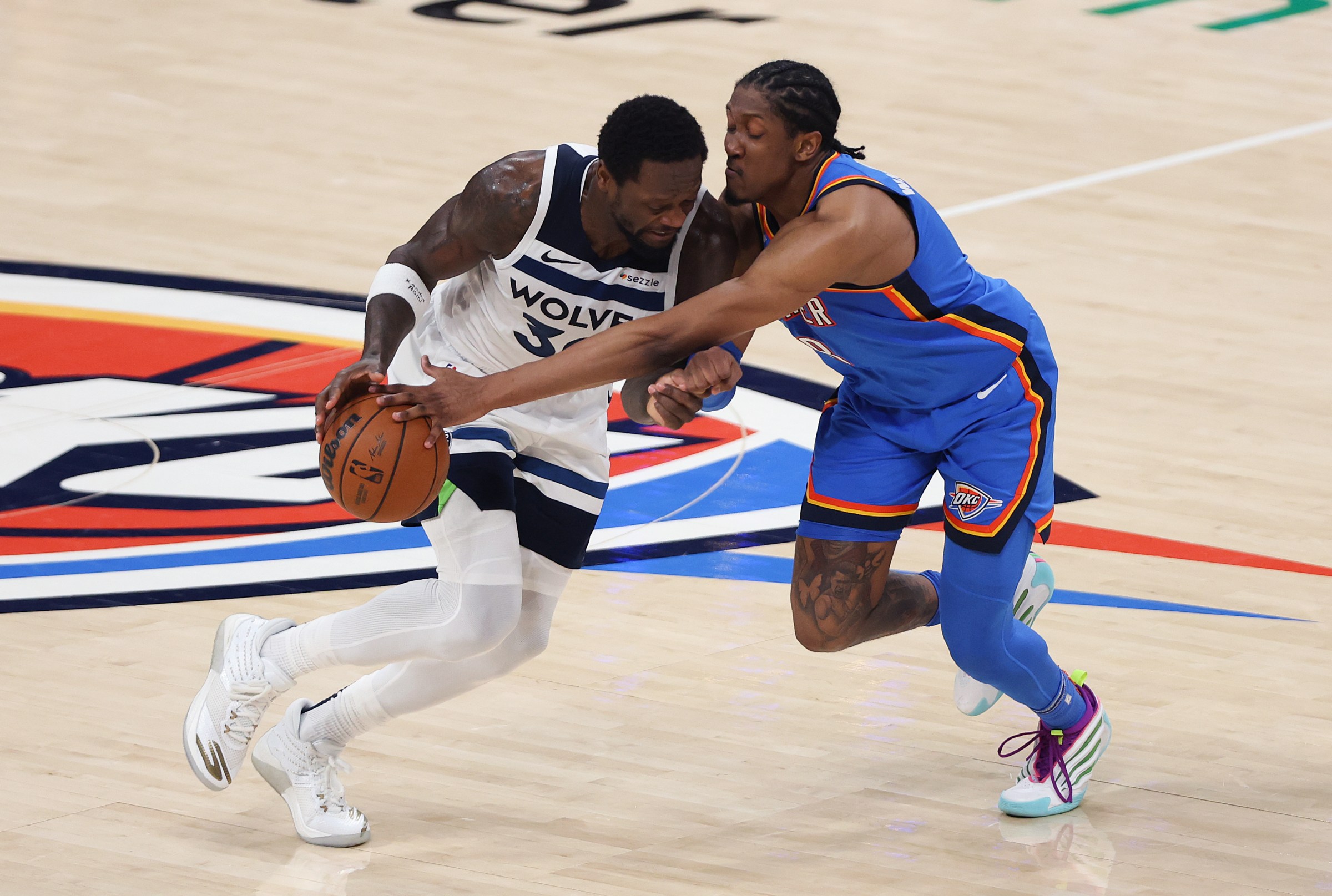 OKLAHOMA CITY, OKLAHOMA - MAY 28: Jalen Williams #8 of the Oklahoma City Thunder defends against Julius Randle #30 of the Minnesota Timberwolves during the third quarter in Game Five of the Western Conference Finals of the 2025 NBA Playoffs at Paycom Center on May 28, 2025 in Oklahoma City, Oklahoma. NOTE TO USER: User expressly acknowledges and agrees that, by downloading and or using this photograph, User is consenting to the terms and conditions of the Getty Images License Agreement. (Photo by Matthew Stockman/Getty Images)